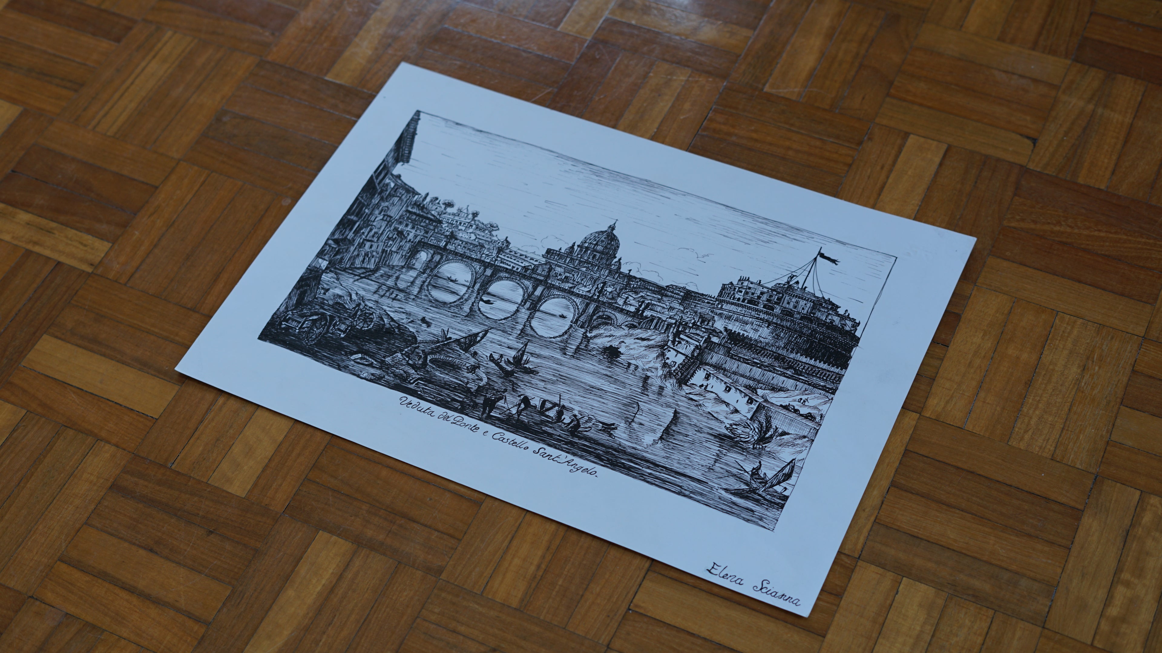 Black and white print of a cityscape on a wooden floor